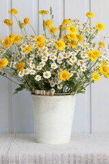 Wildflowers daisies bouquet in rustic white bucket