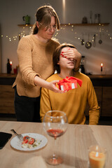 Romantic Surprise. Woman Gives Gift to Man on Valentine's Day, Closes Eyes, Celebrates at Home