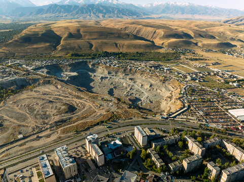 Aerial view of a large sand and gravel extraction quarry adjacent to Microdistrict 11 in Bishkek, Kyrgyzstan