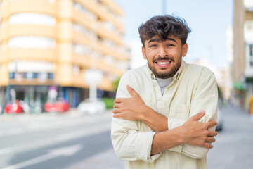Young Arabian handsome man at outdoors freezing