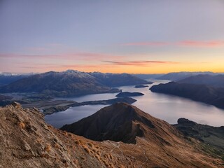 Sunrise over Roy’s Peak in Wanaka, New Zealand, seen from the hiking trail. Golden morning light...