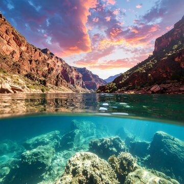A breathtaking split-level view of a canyon's tranquil waters at sunset, revealing both the above and below-water worlds
