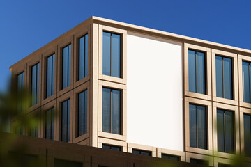 Blank billboard mockup on modern glass facade building under clear blue sky, ideal for advertising or branding concept presentation. 3D Rendering