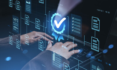 Digital certification icon and virtual documents over hands typing on laptop representing secure data approval and quality assurance concept.
