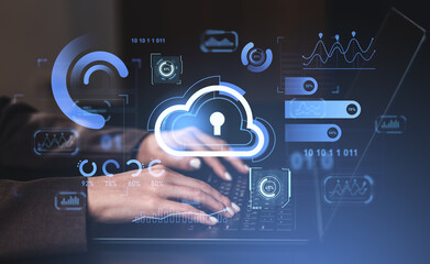 Hands typing on keyboard with cloud security icons and data analytics overlays on dark blue background. Cybersecurity and cloud computing concept.