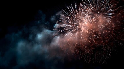 Spectacular fireworks explode and illuminate the night sky with colorful bursts and smoke