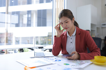 Stressed businesswoman overwhelmed with work and deadlines at the office.