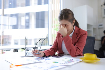 Stressed businesswoman overwhelmed with work and deadlines at the office.