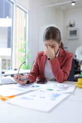 Stressed businesswoman overwhelmed with work and deadlines at the office.