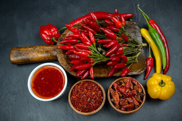 Hot spices: chili peppers with sauce and powder