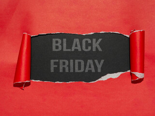 A red paper that has been torn to reveal a dark surface, displaying the text 