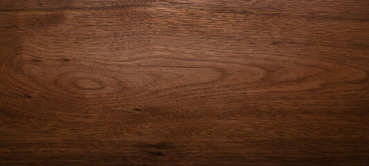 Wide format black walnut natural texture desktop background. Walnut wood texture background. 