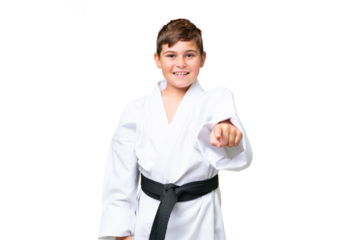 Little caucasian kid doing karate over isolated chroma key background pointing front with happy expression