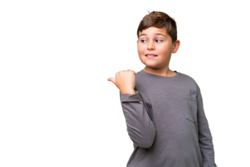 Little caucasian kid over isolated chroma key background pointing to the side to present a product