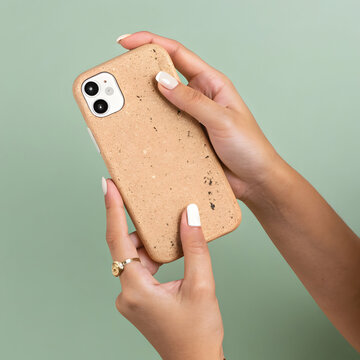 Eco-Friendly Cork Phone Case in Hands on Green Background