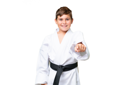 Little caucasian kid doing karate over isolated chroma key background pointing front with happy expression