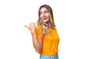 Young Uruguayan woman over isolated background pointing to the side to present a product