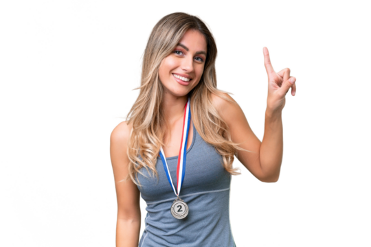 Young pretty sport Uruguayan woman with medals over isolated background showing and lifting a finger in sign of the best