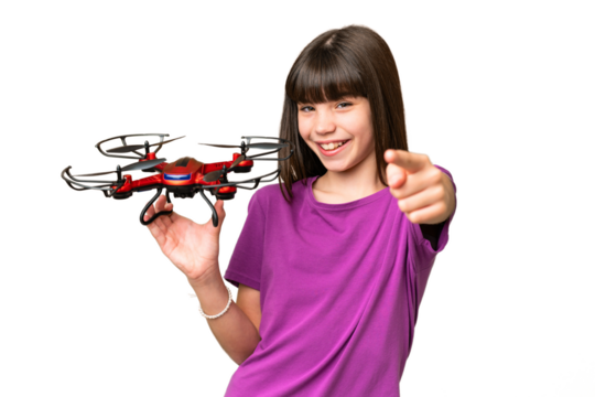 Little caucasian girl holding a drone over isolated background points finger at you with a confident expression