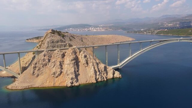 Aerial view of the Krk Bridge, suspended above the Adriatic Sea. This infrastructure connects the island of Krk to the Croatian coast