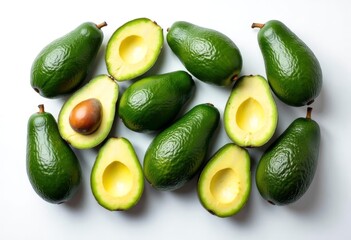 Bright ripe avocados, whole and cut, on a white background