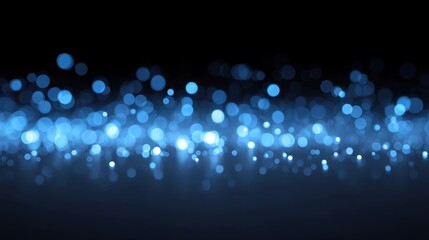 Ethereal blue bokeh effect with soft light spots creating a dreamy atmosphere on a dark background for creative projects and graphic designs