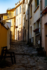 Obraz premium View of colourful Collioure, narrow streets and yellow, pink, orange houses, summer vacation destination town with historical buidings and beaches, Pyrenees-Orientales, France