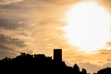 Silhouette of an Arab castle atop a mountain at dawn.