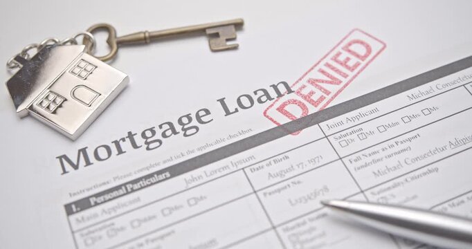 Mortgage loan form marked DENIED in red stamp, representing rejection of housing credit, financial failure, and banking loan denial.