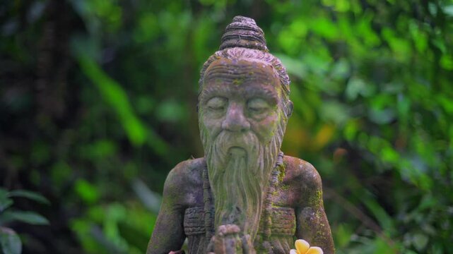 Ancient Balinese Stone Statue of Bearded Monk in Jungle Temple