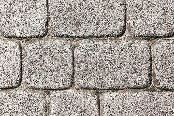 Stone pavement texture. Gray cobblestone surface background. Square stone pattern closeup. Urban architecture flooring. Natural stone block wall. Exterior outdoor construction material.
