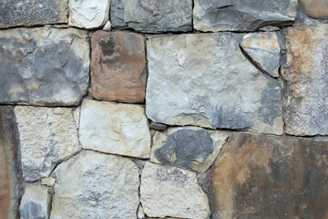 Natural texture of natural stone in different shapes and colors. stone laying of stone. the background of a stone wall. A copy of the space.