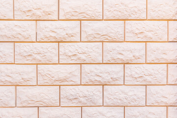 Abstract background of laying a beige brick wall. brick texture in a light tone. A blank layout for design. A copy space. A sample of a brick wall