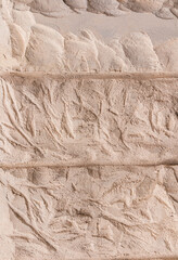 A fragment of the texture of a beige stone wall. parallel large stone slabs. Embossed surface. A copy of the space. vertical view.
