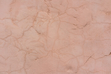 Beautiful beige surface of the painted wall in beige sand. Embossed texture with a beautiful pattern. A copy of the space.