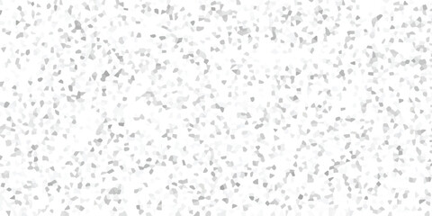 Abstract mosaic background with a random distribution of small, irregular grey and white geometric fragments creating a textured visual surface for creative projects