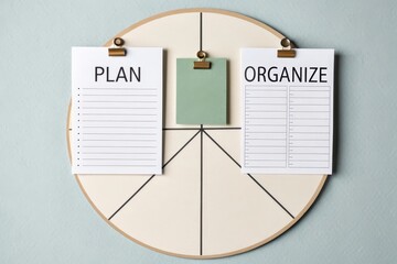 Flatlay of Plan and Organize Papers on a Circle Board