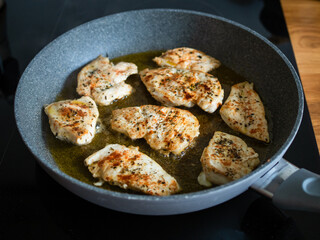 Frying chicken cutlets in frying pan, close-up	