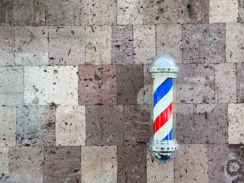 Classic Vintage Barbershop Spinning Barber Pole Red and Blue Striped Helix Sign. High quality photo - Powered by Adobe