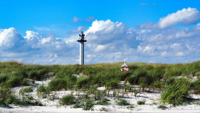 The Dueodde lighthouse, Denmark's tallest, rises elegantly from Bornholm's famous sand dunes. A landmark on the coast.