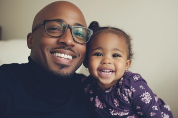 A joyful father and daughter, close together, sharing a warm and loving moment.