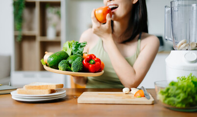 woman cutting fresh vegetables in a bright home kitchen. Concept of healthy lifestyle, clean eating, vegan diet, nutrition, and wellness