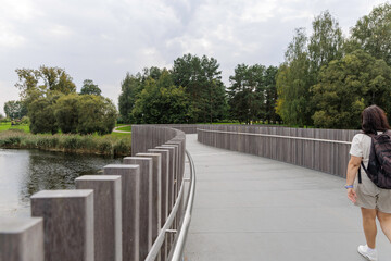 Curved elevated wooden walkway in a park.
