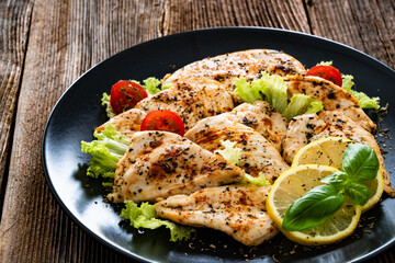 Fried chicken fillets on wooden table	