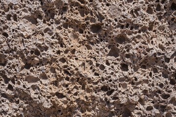 Porous volcanic stone texture, detailed close-up of natural rock surface with cavities. Perfect geology background for scientific, educational, construction or abstract design use