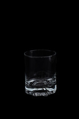 Empty glass on black background – minimalist studio setup