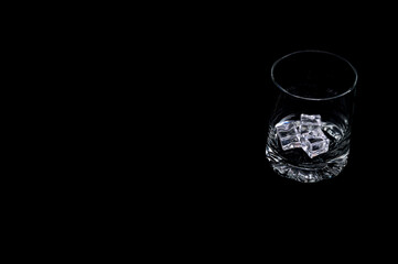 Empty glass on black background – minimalist studio setup