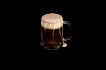 Frothy Mug of Dark Beer on Black Background