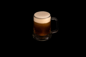 Frothy Mug of Dark Beer on Black Background
