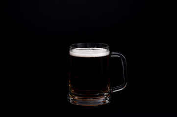 Glass Mug of Dark Beer on Black Background